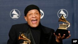 FILE - In this Sunday, Feb. 11, 2007, file photo, Al Jarreau poses with his awards for best pop instrumental performance for "Mornin'" and best traditional R&B vocal performance for "God Bless the Child" at the 49th Annual Grammy Awards in Los Angeles. Jarreau died in a Los Angeles hospital early Sunday, Feb. 12, 2017, according to his official Twitter account and website.