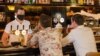 Customers sit at a bar on the first day of reopening in Auckland, New Zealand, on Dec. 3, 2021, as the country revamps its domestic COVID-19 response.