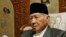 FILE - Former Indonesian dictator Suharto sits in his home in Jakarta, Oct. 24. 2006. 