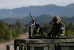 A soldier forming part of the National Guard mans an immigration checkpoint heading north out of Comitan, Chiapas state, Mexico, June 16, 2019.