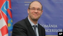 FILE - Croatia's Minister of Foreign and European Affairs Davor Ivo Stier, left, after a press briefing in Bucharest, Romania, March 14, 2017. 