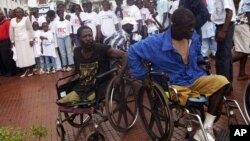 Two war victims seen in wheelchairs at the launch of Liberia's Truth and Reconciliation Commission in Monrovia, June 22, 2006. An accounting of atrocities committed during nearly a quarter-century was aimed at setting the stage for a long-term peace. (AP Photo/Pewee Flomoku)