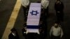 Members of the Knesset guard carry the flag-draped coffin of former Israeli prime minister Ariel Sharon outside the Knesset, Israel's parliament, in Jerusalem Jan. 12, 2014. 