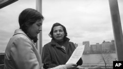 FILE - in this Nov. 4, 1971 photo, Eddie Benton-Benai shows a prayer he wrote to Linda Jeffers, of Vineyard Haven, Martha's Vineyard, Mass., a member of the Wampanoag Tribe in Cambridge, Mass.