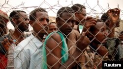 Pekerja migran Ethiopia yang mencari pekerjaan di Arab Saudi kembali pada tanggal 16 Maret 2012, di Haradh, kota di Yaman barat di dekat lokasi di mana pemerintah Arab Saudi mendirikan pagar di sepanjang perbatasan. (Reuters)