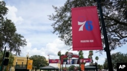 A Philadelphia 76ers banner and other NBA team logos are displayed outside arenas Aug. 28, 2020, in Lake Buena Vista, Fla. 