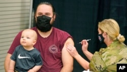 A man receives a COVID-19 vaccine, March 25, 2021, in Spanish Fork, Utah.