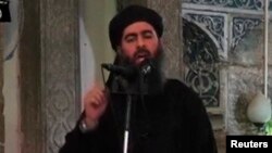 FILE - A video image shows a man purported to be Abu Bakr al-Baghdadi, the Islamic State's senior leader. The video was released in July 2014.