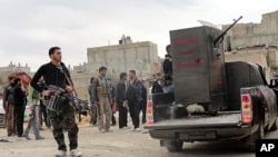 Members of the Free Syrian Army are seen deployed in al-Bayada, Homs, February 29, 2012.