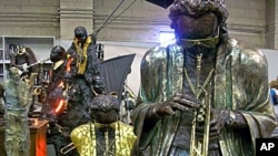 A larger-than-life bronze sculpture of trumpeter Miles Davis from Dwight's Jazz series stands in the artist's studio.