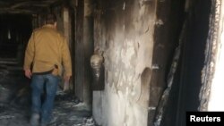 Damaged burned corridor of the Intercontinental Hotel is seen a day after an attack in Kabul, Afghanistan, Jan. 22, 2018. 