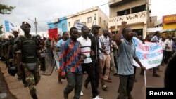 Opposition supporters hold up placards during a protest against what they say were irregularities in the first-round vote count, ahead of the second round, in Bamako, Mali, Aug. 11, 2018.
