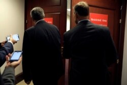 FILE - Members of Congress head to a resticted area for a closed-door deposition held as part of House Democrats' impeachment inquiry into President Donald Trump on Capitol Hill in Washington, Oct. 23, 2019.