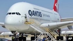 In this July 6, 2020, file photo, a Qantas Airbus A380 arrives in Victorville, Calif. Qantas said that once a virus vaccine becomes widely available, the carrier will likely require it before passengers can travel abroad or land in Australia. (AP Photo/Matt Hartman, File)