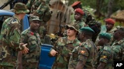 FILE - A U.S. Army special forces officer speaks with troops from the Central African Republic and Uganda, in Obo, Central African Republic, April 29, 2012. 