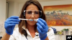 An injured woman looks on as another speaks on her mobile phone following twin blasts at Brussels airport in Zaventem. Airlines cancelled hundreds of flights and European railways froze links with Brussels after a series of bomb blasts killed around 35 people in the city's airport and a metro station, sparking a broad security response.