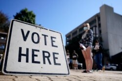 Voters stand in a line as they wait to vote early in Athens, Ga, Oct. 19, 2020. (AP)