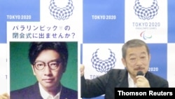 FILE - Hiroshi Sasaki, Tokyo 2020 Paralympic Games executive creative director, displays a portrait of Olympics opening ceremony show director Kentaro Kobayashi during a news conference in Tokyo, Japan, in this photo taken by Kyodo in December 2019.
