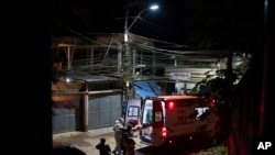 Mobile Emergency Care Service (SAMU) workers carry an elderly COVID-19 patient to an ambulance in Duque de Caxias, Rio de Janeiro state, Brazil, Wednesday, April 7, 2021. (AP Photo/Felipe Dana)