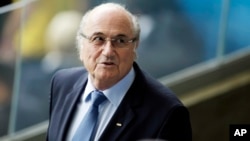 FILE - Fifa President Sepp Blatter waits for the beginning of the World Cup semifinal soccer match between Brazil and Germany at the Mineirao Stadium in Belo Horizonte, Brazil, July 8, 2014.