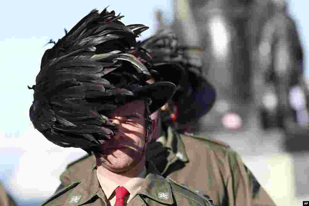 The feathered hat of an Italian Bersagliere is blown by a strong wind as he stands at attention before the meeting between Russian President Vladimir Putin and Italian Premier Enrico Letta, in Trieste, Italy.