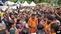 Protesters who are opposed to allowing women of menstruating age to enter the Sabarimala temple chant devotional hymns as they gather at Nilackal, a base camp on way to the mountain shrine in Kerala, India, Oct. 17, 2018. 