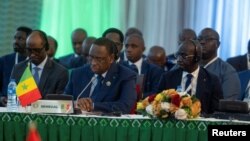 Senegal's President Macky Sall listens to the opening speech during an ECOWAS meeeting in Abuja, Nigeria, on Feb. 24, 2024.