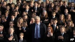 The Chulmleigh College school choir sings and signs 'A Lovely Day' as Britain's Prime Minister and Conservative Party leader, Boris Johnson visit in Chulmleigh, England, Nov. 28, 2019, ahead of the general election on Dec. 12. 