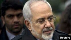 FILE - Iranian Foreign Minister Javad Zarif is seen as he walks through a courtyard at the Beau Rivage Palace Hotel during an extended round of talks in Lausanne, April 1, 2015. 