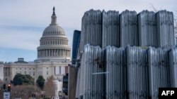 Security fencing is stacked near the US Capitol building on the National Mall ahead of the January 6th certification of the 2024 Presidential Election in Congress in Washington, DC, on January 5, 2025. (Photo by Allison ROBBERT / AFP)