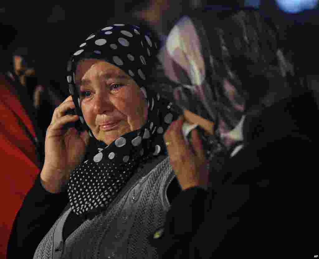 Family members wait outside a coal mine where more than 200 miners have been trapped after an explosion, in Soma, western Turkey, May 14, 2014.