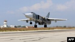FILE - A Russian Sukhoi Su-24 bomber takes off from the Hmeimim airbase in the Syrian province of Latakia, October 3, 2015.