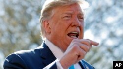President Donald Trump speaks to members of the media on the South Lawn of the White House in Washington, before boarding Marine One helicopter, April 10, 2019. 