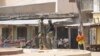 FILE - Security forces stand guard at the site of bomb explosion at a market in Maiduguri, Nigeria, March 7, 2015. On Friday, dozens of people were killed when two female suicide bombers attacked a market in the town of Madagali.