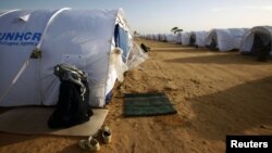Malian refugee prays at UNHCR camp for civilians fleeing violence in Libya, near the border crossing of Ras Jdir, March 3, 2011.