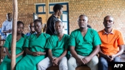 FILE - Four journalists of Burundi's independent media Iwacu Press Group and their driver appear at the High Court in Bubanza, western Burundi, Dec. 30, 2019, accused of complicity in endangering the internal security of the state. 