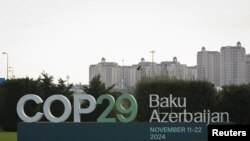 A view shows a sign of the COP29 United Nations Climate Change Conference with a backdrop of the cityscape in Baku, Azerbaijan, Oct. 31, 2024. 