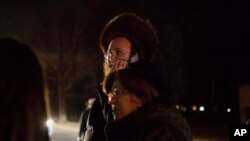 Orthodox Jewish people gather on a street in Monsey, N.Y., Sunday, Dec. 29, 2019, following a stabbing late Saturday during a Hanukkah celebration.