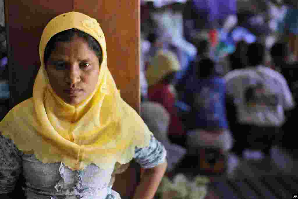 A Rohingya woman stands at a temporary shelter in Bayeun, Aceh Province, Indonesia, June 1, 2015.