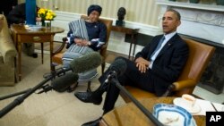 President Barack Obama meets with Liberian President Ellen Johnson Sirleaf to discuss the ongoing response to the Ebola outbreak in Western Africa and Liberia's recovery from the deadly virus, in the White House Oval Office in Washington, Feb. 27, 2015.