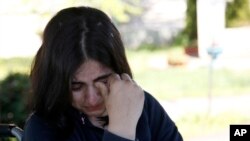 Fatima Bakhshi, a migrant from Afghanistan, cries in a small care home in the village of Doljevac, in southern Serbia, April 10, 2017.