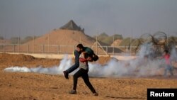 A wounded Palestinian is evacuated during a protest calling for lifting the Israeli blockade on Gaza and demanding the right to return to their homeland, at the Israel-Gaza border fence, in the southern Gaza Strip, Sept. 21, 2018.