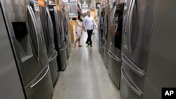 FILE - Shoppers examine refrigerators at a Home Depot store in Boston, Sept. 23, 2019. The U.S. announced May 3, 2021, that it will phase out hydrofluorocarbons found in refrigerators, freezers and air conditioners. 