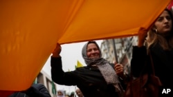 Pro-Kurdish people shout slogans as they march during a protest in Brussels against Turkey's invasion of northern Syria, Oct. 16, 2019. 