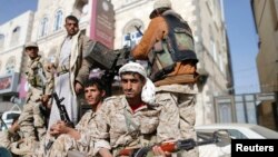 FILE - Houthi fighters ride in a truck while patrolling a street in Sanaa, Yemen, Jan. 21, 2015.