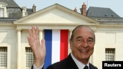 FILE - France's President Jacques Chirac waves as he leaves a French citizenship naturalization ceremony in Tours, central France, June 29, 2006.