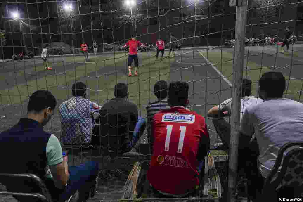 Young men in Nagrig village gather to watch a football match. Some say they dream of being the next Mohamed Salah.