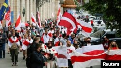 File - Activists march during a rally in support of Belarusian anti-government movement in Kyiv, Ukraine, May 30, 2021. 