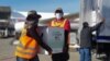 FILE - Workers unload 1.5 million doses of Moderna vaccine donated by the U.S. through the COVAX scheme, at the Armando Escalon aerial base, in San Pedro Sula, Honduras, June 27, 2021, in this handout picture released by the Honduran presidency.