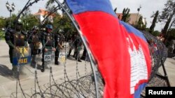 Police officers stand guard at Freedom Park during a protest in central Phnom Penh July 15, 2014.
